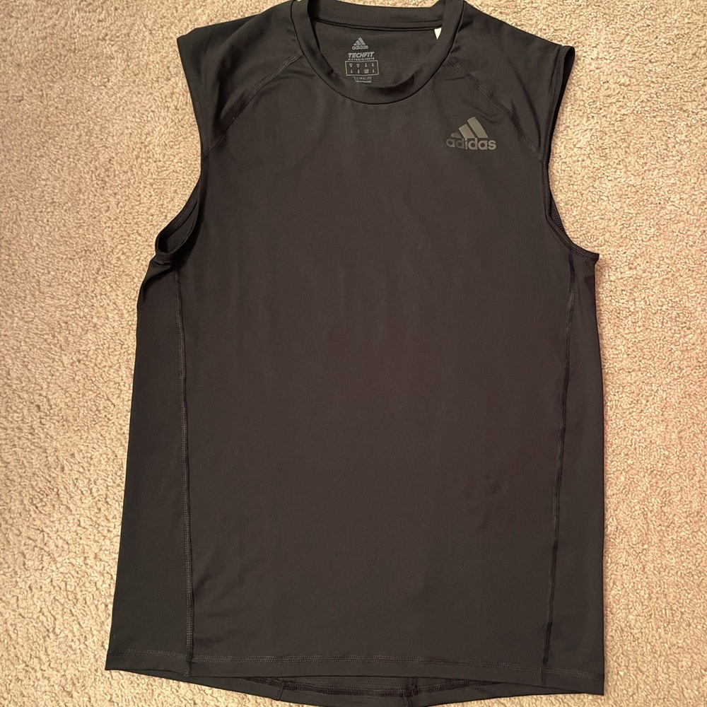 This is a medium top in black adidas is the brand